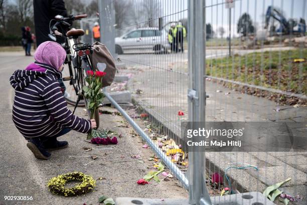 Child places flowers during a demolition of Saint Lambertus church following protests by activists on January 9, 2018 in Immerath, Germany. The...