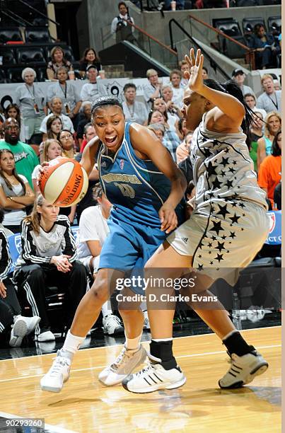 Renee Montgomery of the Minnesota Lynx drives against Helen Darling of the San Antonio Silver Stars on September 1, 2009 at the AT&T Center in San...