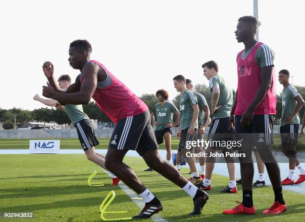 Paul Pogba and Axel Tuanzebe of Manchester United in action during a first team training session at Nad Sheba Sports Complex on January 9, 2018 in...