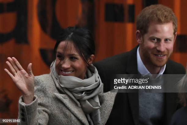 Britain's Prince Harry and his fiancée US actress Meghan Markle arrive for their visit to Reprezent 107.3FM community radio station in Brixton, south...