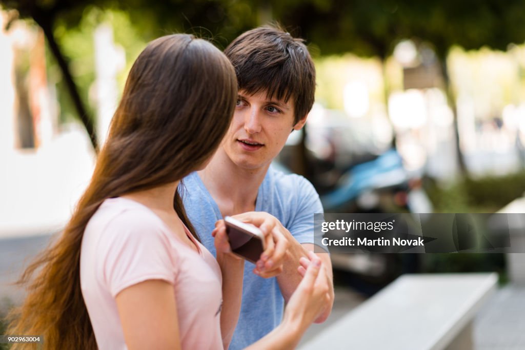 Suspicious woman wants to check boyfriend's phone