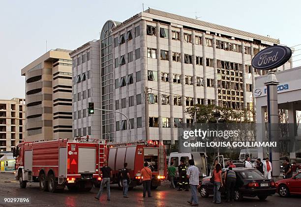 Firebrigade trucks are seen by the damaged Athens Stock Exchange building after a powerful bomb exploded there on September 2, 2009. Two homemade...