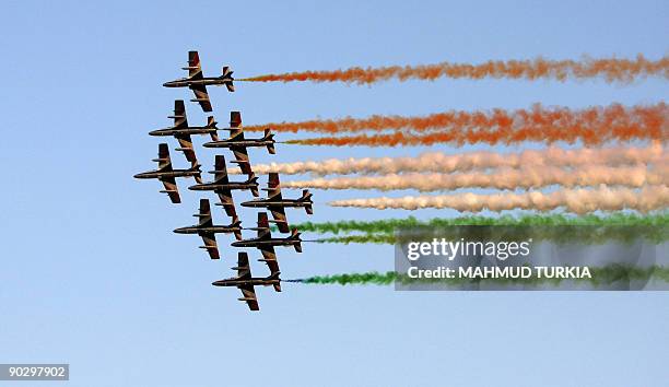 Italian "Frecci Tricolori" acrobatic planes fly overhead foreign troops during a military parade in Tripoli on September 1, 2009 at celebrations...