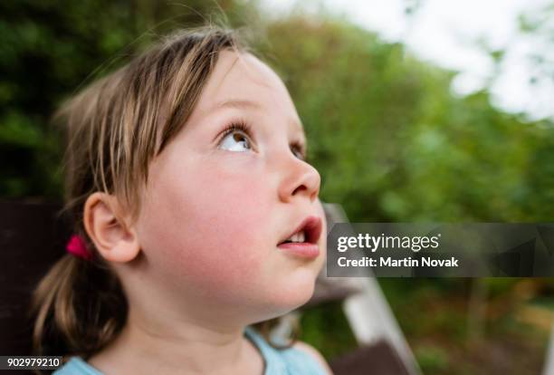 girl child staring at something - young girl looking up stock pictures, royalty-free photos & images
