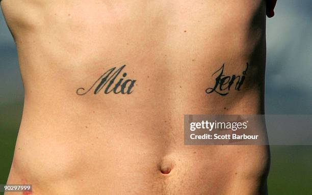 The names of Brendan Fevola's two children Mia and Leni are seen tattooed to his body during a Carlton Blues AFL training session at Visy Park on...