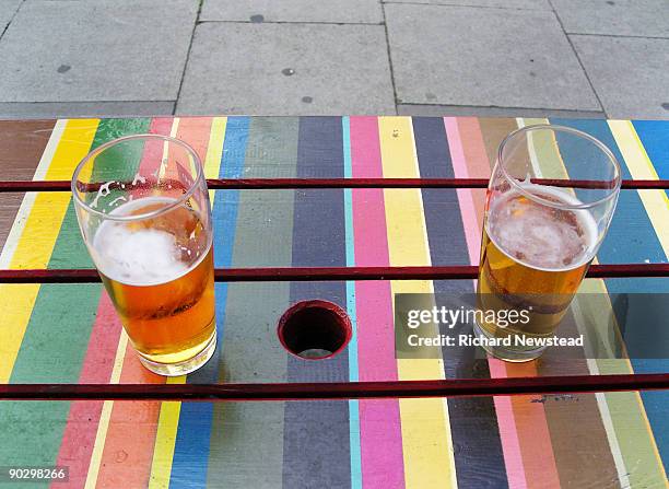 two half drunk pints of beer on a pub table - half full stock pictures, royalty-free photos & images