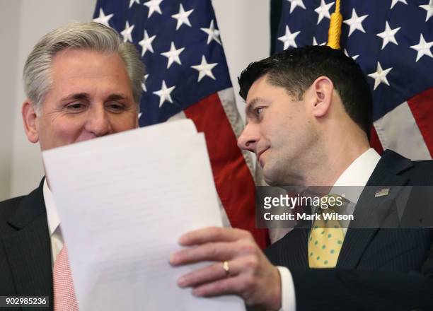 House Speaker Paul Ryan , shows a paper to House Majority Leader Kevin McCarthy , while speaking to the media about the GOP agenda after a meeting...