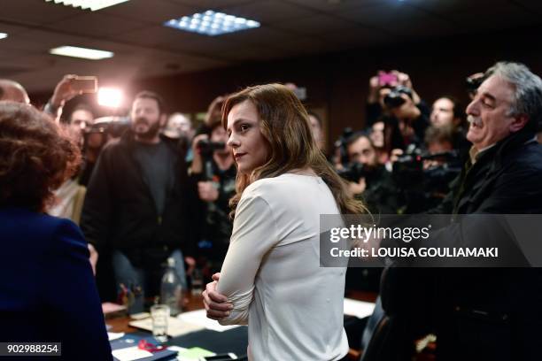 Greek Labour Minister Effie Achtsioglou reacts as Communist-affiliated PAME workers unionists argue with her after storming into the Labour ministry...