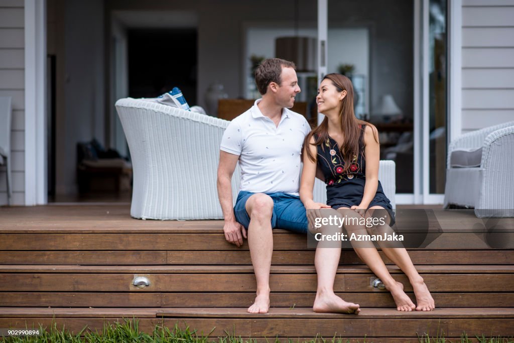 Happy couple sitting on the porch
