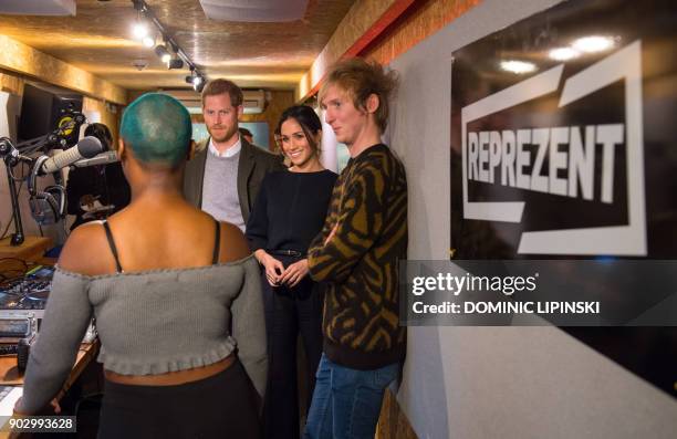 Britain's Prince Harry and his fiancée US actress Meghan Markle are shown around the studio during a visit to Reprezent 107.3FM community radio...