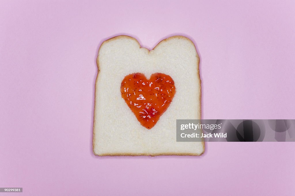 Heart-shaped jam is on on bread