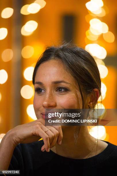 Britain's Prince Harry's fiancée, US actress Meghan Markle gestures during a visit to Reprezent 107.3FM community radio station in Brixton, south...