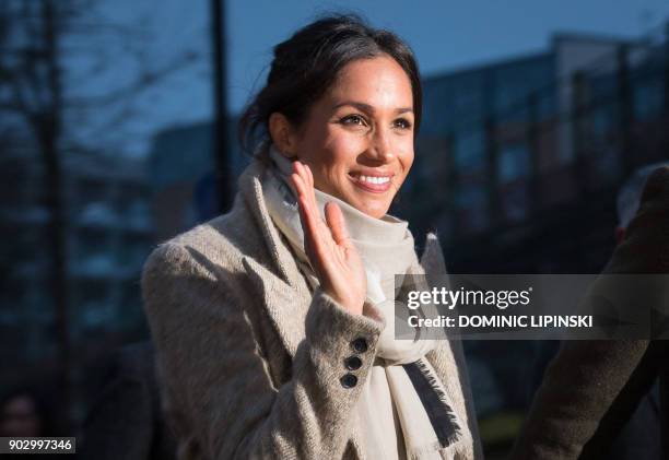 Fiancée of Britain's Prince Harry's, US actress Meghan Markle waves to well-wishers as they leave after a visit to Reprezent 107.3FM community radio...