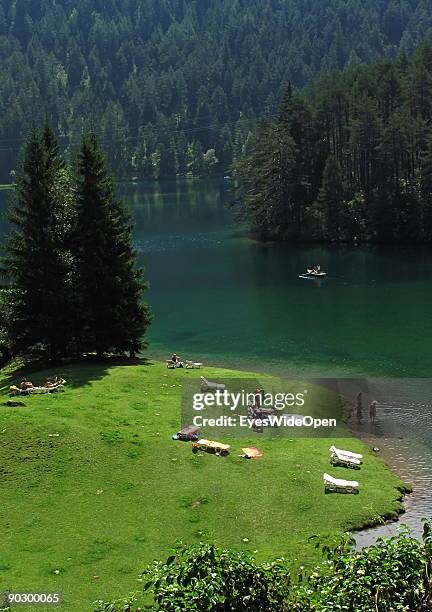 People swimming and rowing on the Fernsteinsee at the austrian mountain pass "Fernpass" on August 1, 2009 in Nassereith near Innsbruck, Austria.