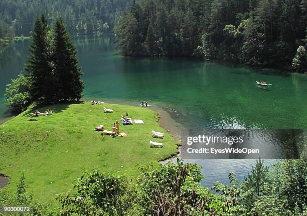 People swimming and rowing on the Fernsteinsee at the austrian mountain pass "Fernpass" on August 1, 2009 in Nassereith near Innsbruck, Austria.