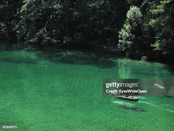 People swimming and rowing on the Fernsteinsee at the austrian mountain pass "Fernpass" on August 1, 2009 in Nassereith near Innsbruck, Austria.