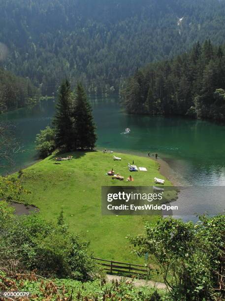 People swimming and rowing on the Fernsteinsee at the austrian mountain pass "Fernpass" on August 1, 2009 in Nassereith near Innsbruck, Austria.