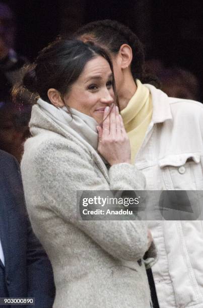 Prince Harry's fiance Meghan Markle gestures as she arrives Pop Brixton to see the broadcaster's work, supporting young people through creative...