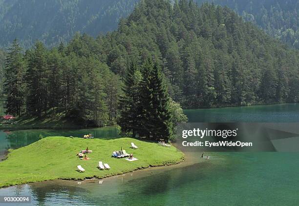 People swimming and rowing on the Fernsteinsee at the austrian mountain pass "Fernpass" on August 1, 2009 in Nassereith near Innsbruck, Austria.