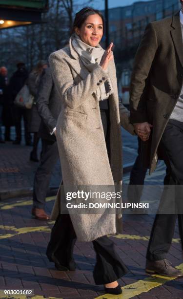 Fiancée of Britain's Prince Harry's, US actress Meghan Markle waves to well-wishers as they leave after a visit to Reprezent 107.3FM community radio...