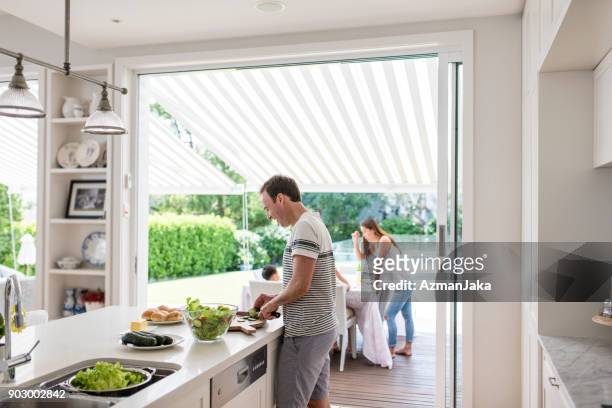 father preparing food for barbecue - familie barbecue stock pictures, royalty-free photos & images