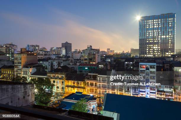 old and new lit buildings at the downtown in yangon (rangoon), myanmar (burma), in the evening. - yangon imagens e fotografias de stock
