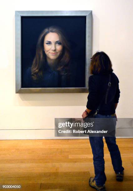 Museum visitor admires a portrait of Catherine, Duchess of Cambridge , at the National Portrait Gallery in London, England. The official portrait was...