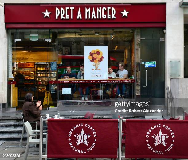 Customers patronize a Pret a Manger shop in London, England. The international sandwich and coffee shop chain based in the United Kingdom is commonly...