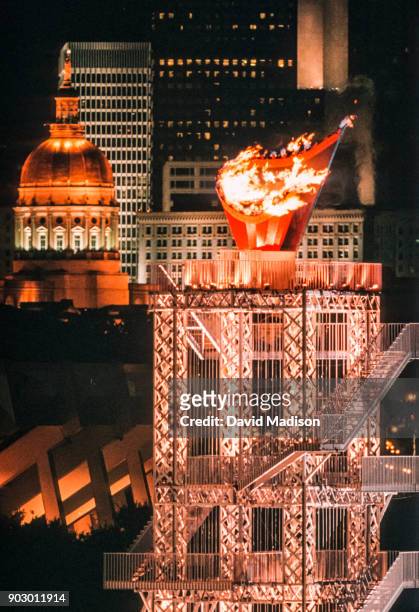 The Olympic Flame and buildings of downtown Atlanta are visible during the Opening Ceremony of the 1996 Olympic Games on July 19, 1996 in Centennial...