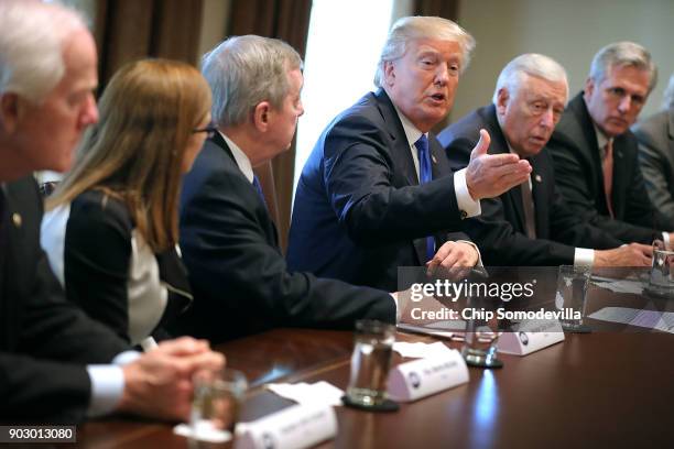 President Donald Trump presides over a meeting about immigration with Republican and Democrat members of Congress, including Senate Majority Whip...