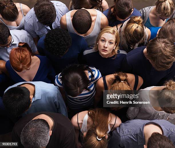 group of people, one looking up - standing out from the crowd stock pictures, royalty-free photos & images