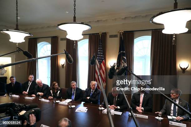 President Donald Trump presides over a meeting about immigration with Republican and Democrat members of Congress, including Sen. Cory Gardner , Sen....