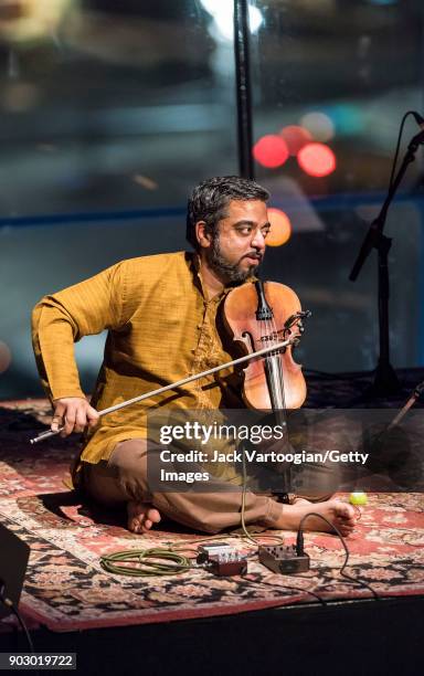 Indian musician Arun Ramamurthy plays violin as he leads his trio during a performance at the South Asian Music and Arts Association's Indo-Jazz...