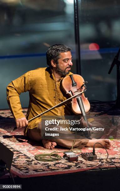 Indian musician Arun Ramamurthy plays violin as he leads his trio during a performance at the South Asian Music and Arts Association's Indo-Jazz...
