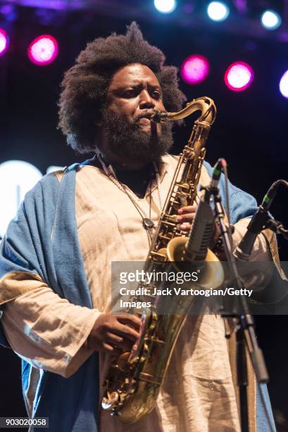 American Jazz musician Kamasi Washington plays tenor saxophone with his band during the Blue Note Jazz Festival at Central Park SummerStage, New...