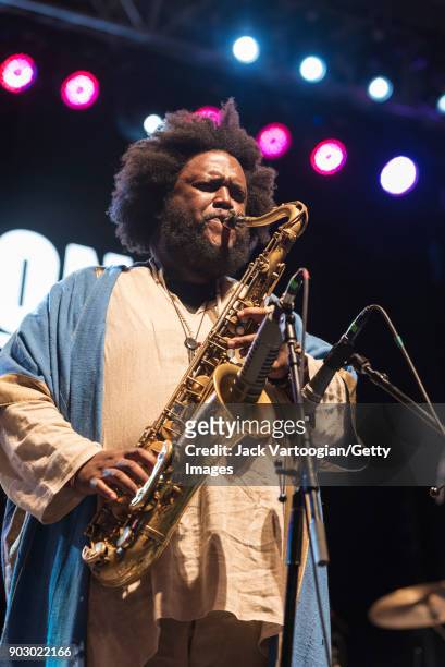 American Jazz musician Kamasi Washington plays tenor saxophone with his band during the Blue Note Jazz Festival at Central Park SummerStage, New...
