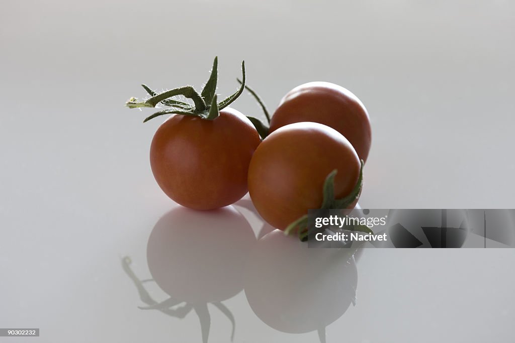 Tomatoes with reflection on white background