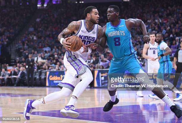 Willie Cauley-Stein of the Sacramento Kings drives towards the basket on Johnny O'Bryant III of the Charlotte Hornets during an NBA basketball game...