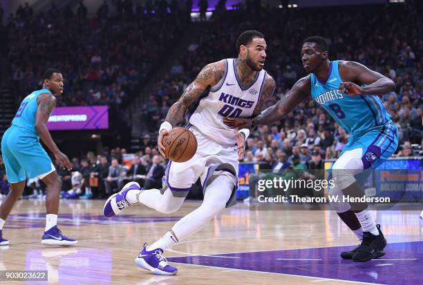 Willie Cauley-Stein of the Sacramento Kings drives towards the basket on Johnny O'Bryant III of the Charlotte Hornets during an NBA basketball game...