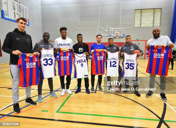 Robert Covington, Dario Saric, T.J. McConnell and Trevor Booker of the Philadelphia 76ers pose with Football Legends Mamadou Sakho, Timothy...