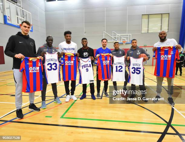 Robert Covington, Dario Saric, T.J. McConnell and Trevor Booker of the Philadelphia 76ers pose with Football Legends Mamadou Sakho, Timothy...