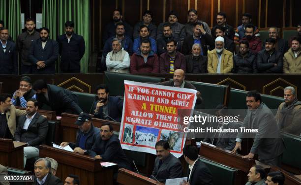 Independent MLA Sheikh Abdul Rasheed holding poster as he protesting during the J&K Legislative Assembly during the budget session, on January 9,...