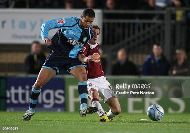 Lewis Montrose of Wycombe Wanderers contests the ball with Ryan Gilligan of Northampton Town during the Johnstone's Paint Trophy First Round Match...
