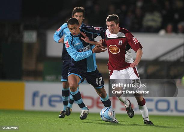 Luke Boden of Northampton Town attempts to move past Lewis Montrose of Wycombe Wanderers during the Johnstone's Paint Trophy First Round Match...