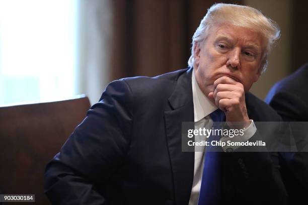 President Donald Trump presides over a meeting about immigration with Republican and Democrat members of Congress in the Cabinet Room at the White...