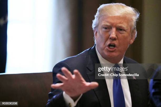 President Donald Trump presides over a meeting about immigration with Republican and Democrat members of Congress in the Cabinet Room at the White...