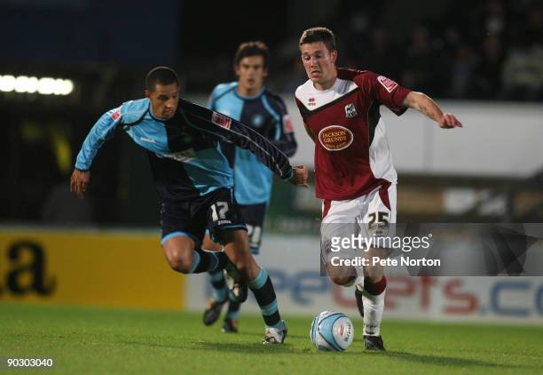 Luke Boden of Northampton Town attempts to move past Lewis Montrose of Wycombe Wanderers during the Johnstone's Paint Trophy First Round Match...