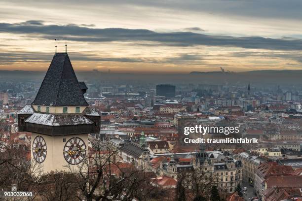 graz clock tower on a december day - turmuhr stock-fotos und bilder