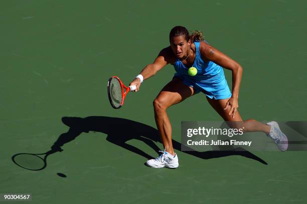 Amelie Mauresmo of France returns a shot against Aleksandra Wozniak of Canada during day three of the 2009 U.S. Open at the USTA Billie Jean King...