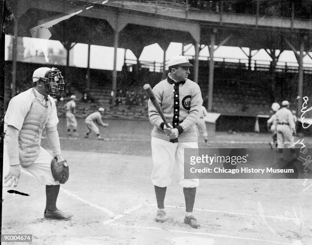 American baseball player Joe Tinker of the Chicago Cubs stands at the plate during batting practice on the field at West Side Grounds, Chicago,...